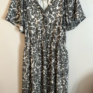 Flowery, black and white dress with floppy sleeves and matching belt.